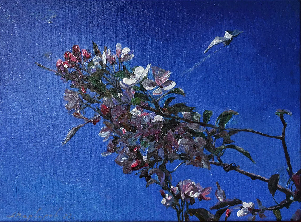 Floral branch with pink and white flowers against a blue background