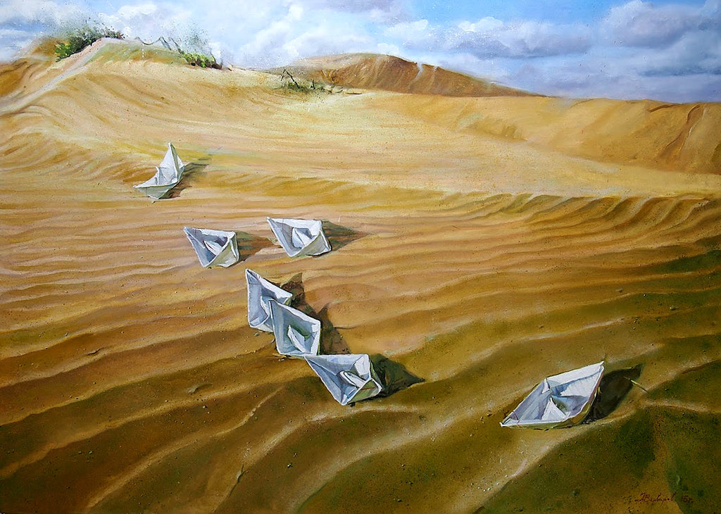 Paper boats on sand with a blue sky and clouds