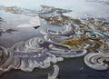 Abstract artwork with swirling patterns and a small figure on a reflective surface