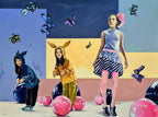 Colorful artwork of four people in costumes with a stylized background featuring butterflies and balls.