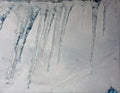 Icicles hanging from a roof in a snowy landscape