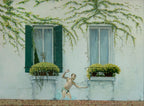 Mural of a child playing in water against a white wall with greenery