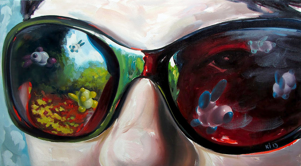 Close-up of sunglasses with colorful reflections of nature and animals.