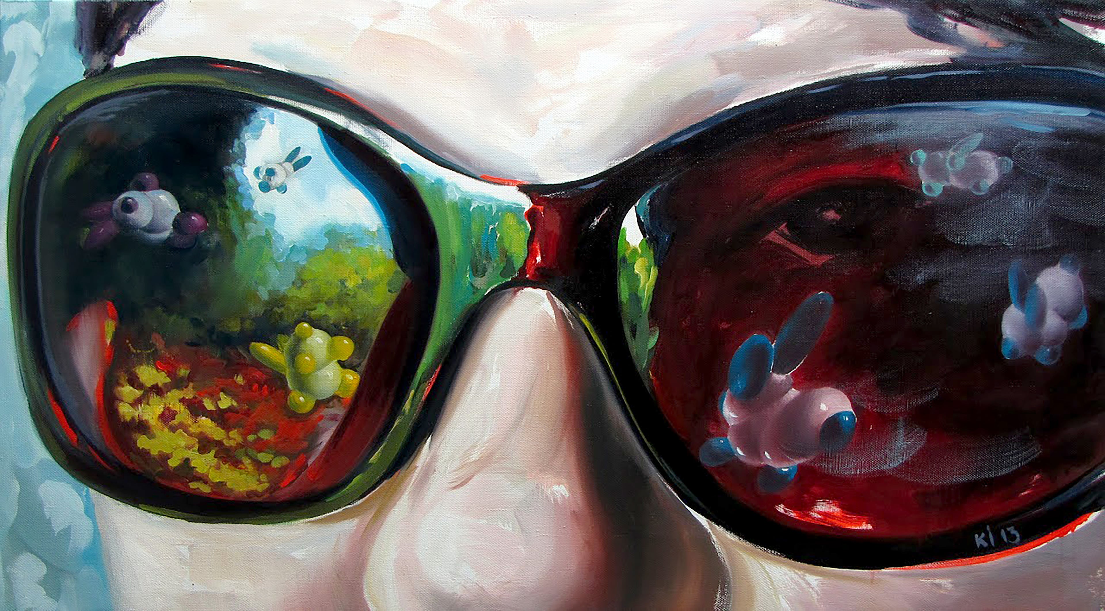 Close-up of sunglasses with colorful reflections of nature and animals.