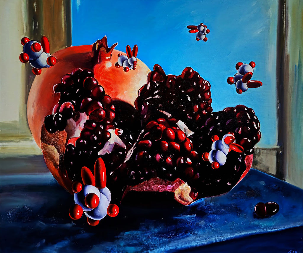 Pomegranate with molecular models on a blue surface