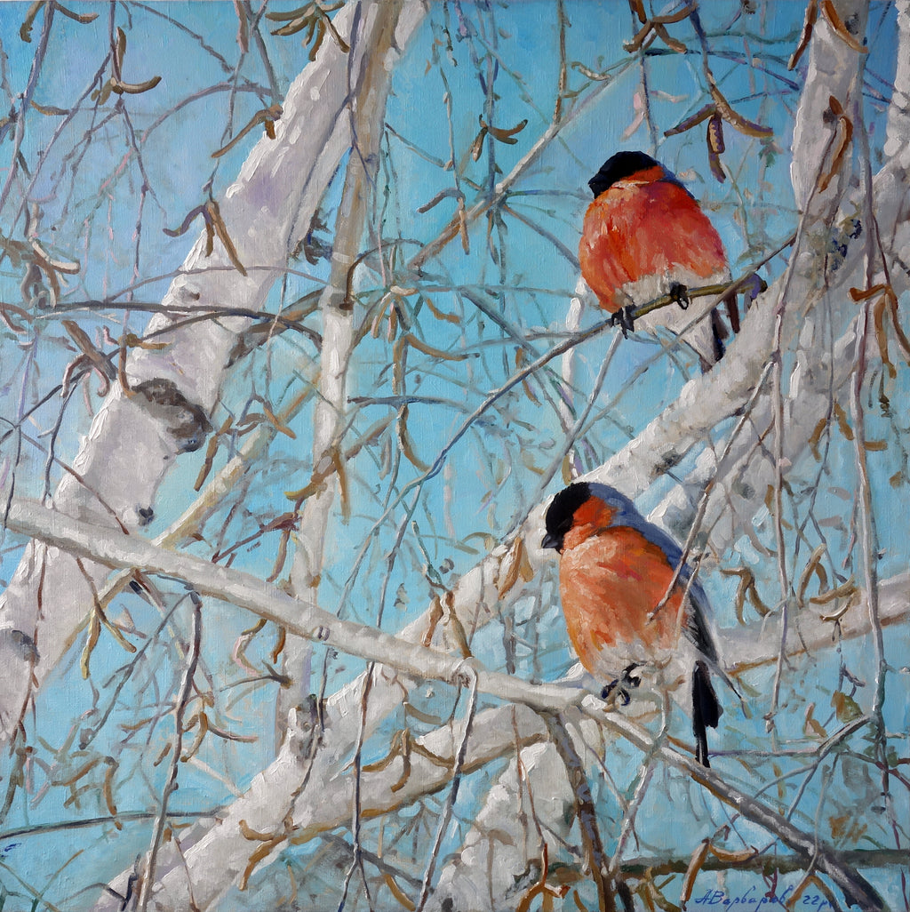 Two birds perched on snow-covered branches against a blue sky