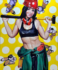 Woman in construction worker attire holding a sledgehammer against a polka dot background