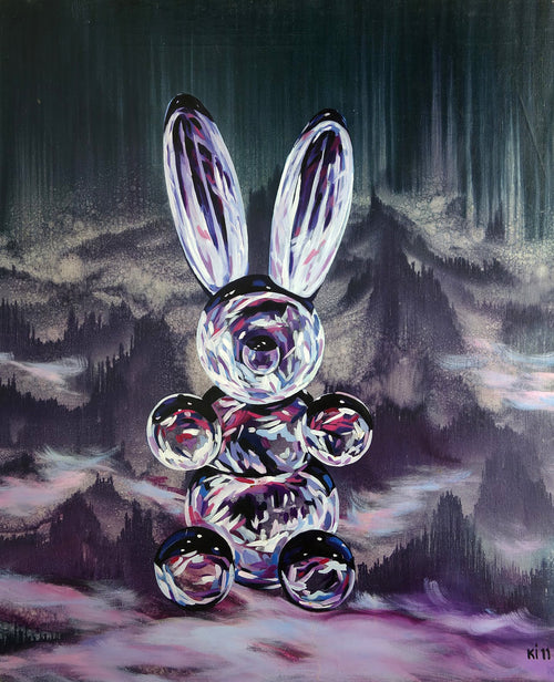 Glass rabbit sculpture with mountainous landscape background