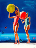 Two women in swimsuits holding large colorful balls against a blue sky.