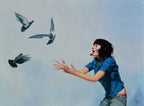 Woman releasing birds into the sky with a blue shirt and jeans against a light blue background