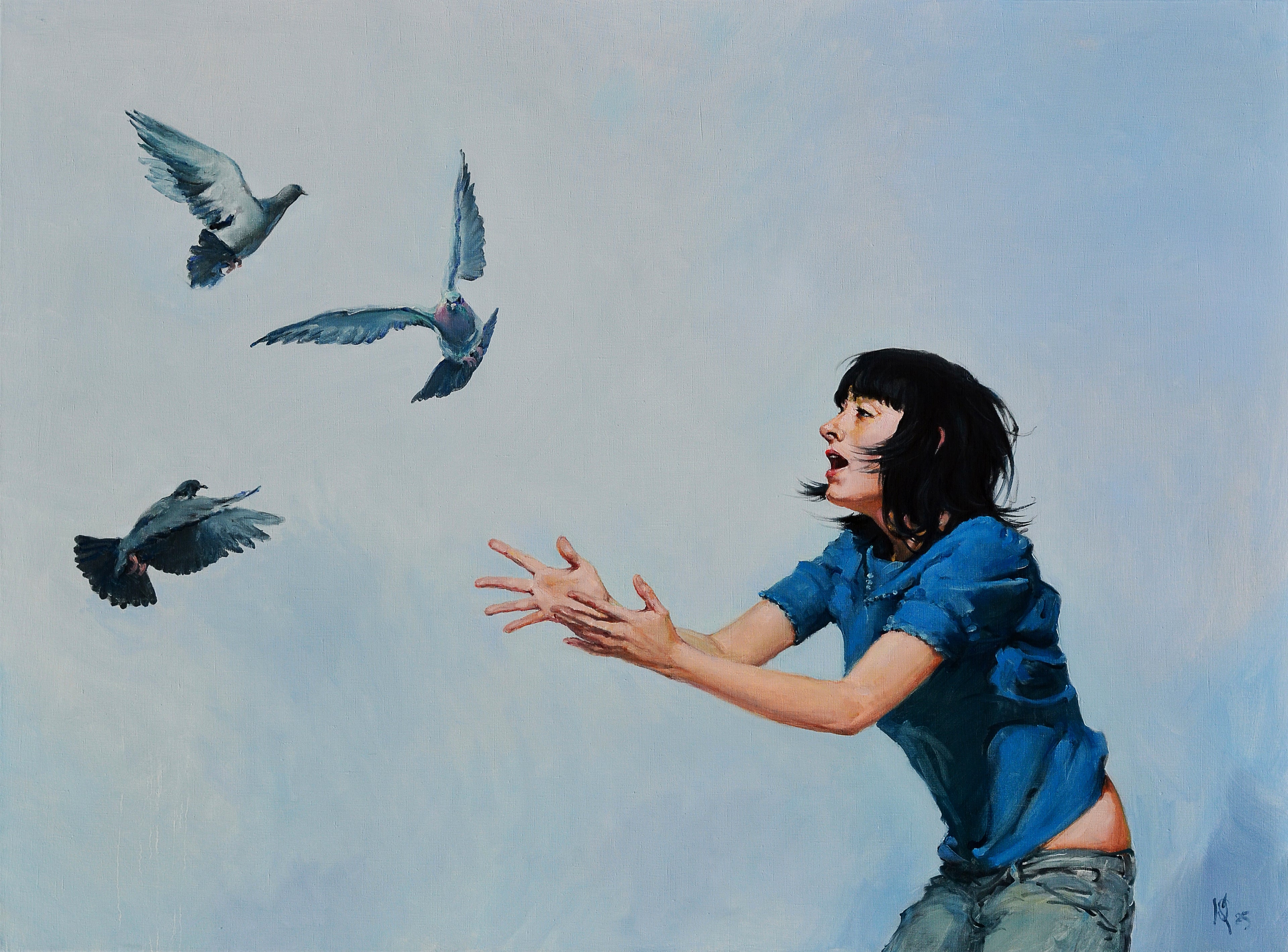Woman releasing birds into the sky with a blue shirt and jeans against a light blue background
