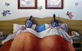 Two people in bed with snorkeling gear on, surrounded by butterfly decorations.