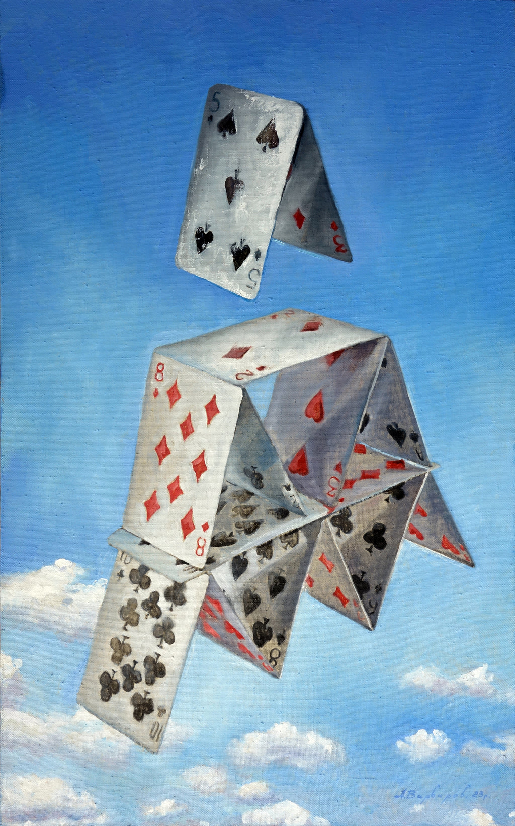 Playing cards stacked into a tower against a blue sky with clouds
