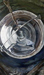 Close-up of a metal container with a rope, showing reflections and textures.