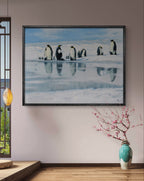 Framed artwork of penguins on ice in a room with a vase and decorative lamp.