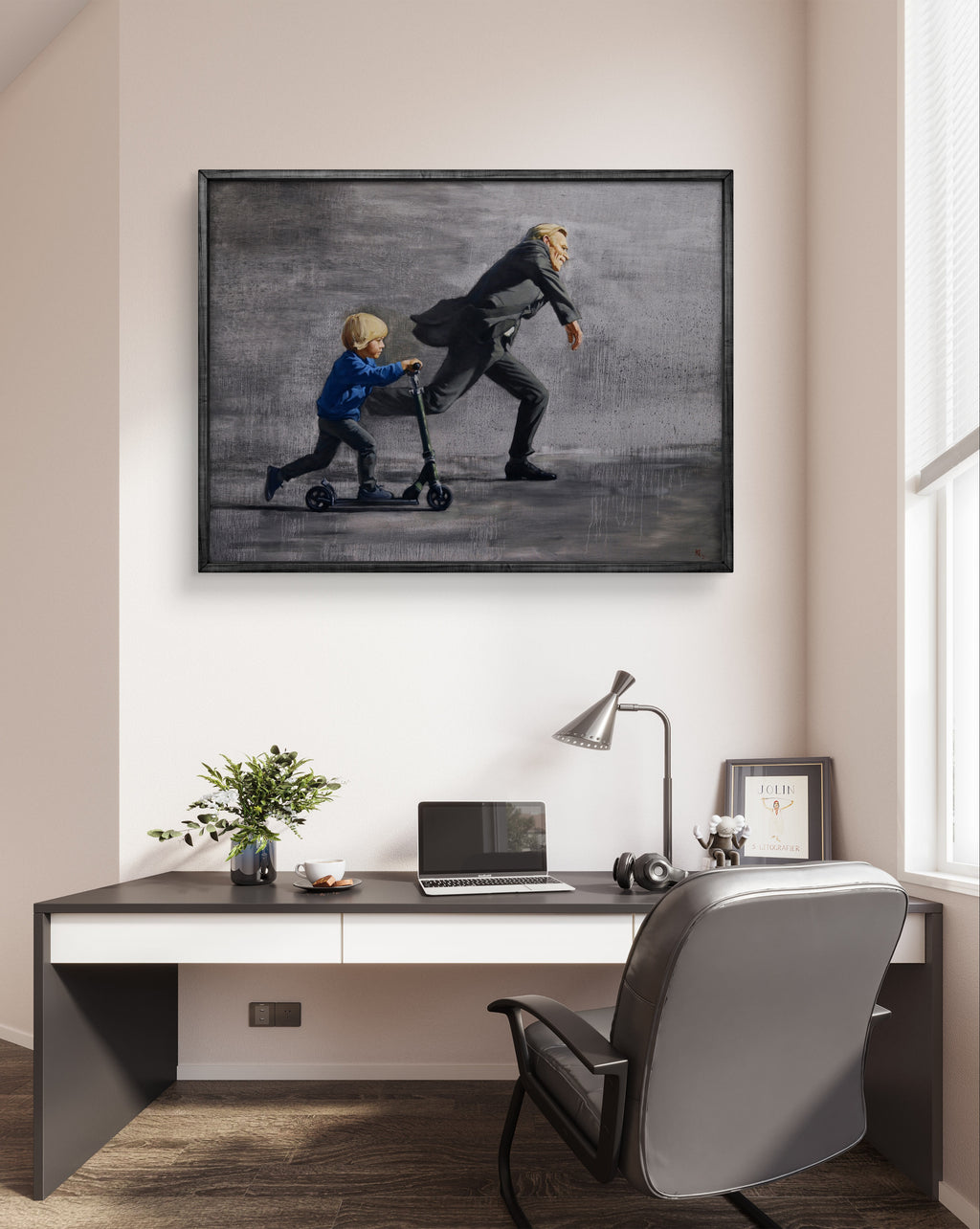Modern office setup with a desk, chair, and framed artwork on the wall.