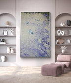 Abstract painting in a modern living room with shelves and a chair.