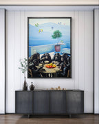Framed artwork of chimpanzees around a table with fruit, mounted on a wall above a dark piece of furniture.