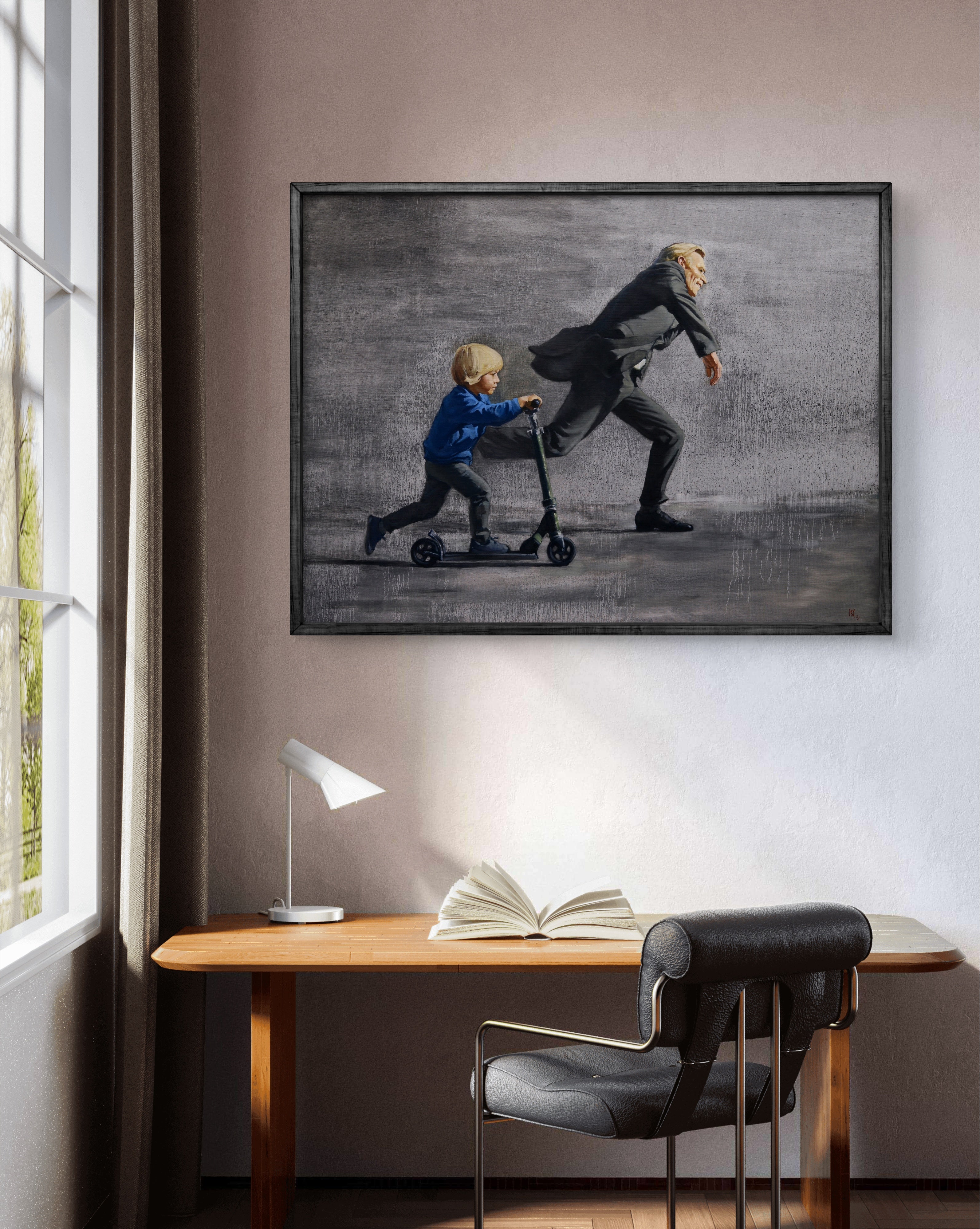 Framed artwork of a man and child on a scooter above a desk with an open book.