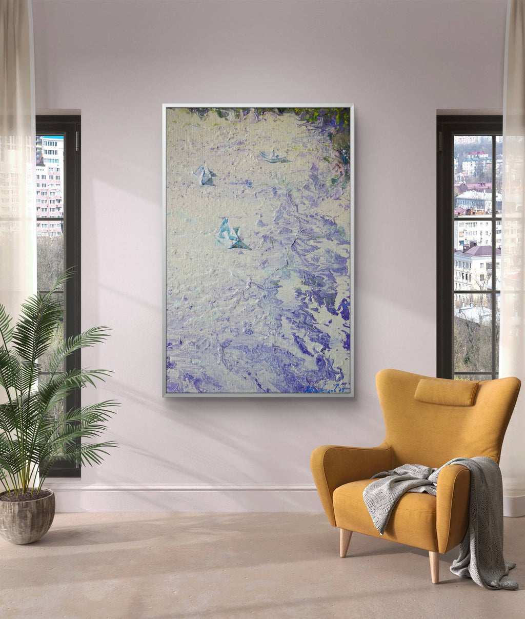 Yellow armchair with a blanket in a room with a large abstract painting on the wall.
