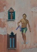 Man in green shorts holding a purple towel against a textured wall with windows.