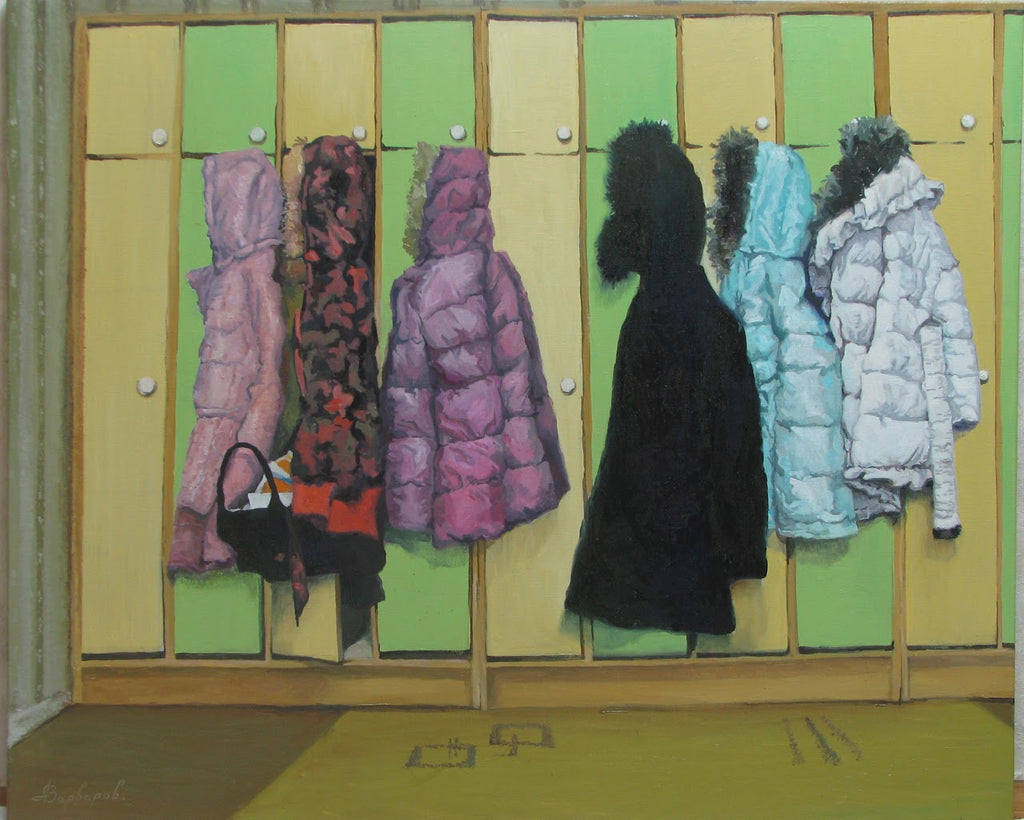 Colorful coats hanging on a wooden locker with green and yellow panels.