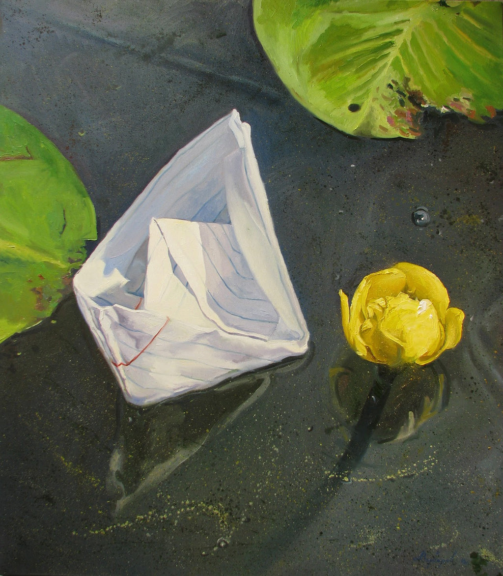 White paper boat with a red string on water, surrounded by green leaves