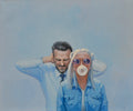 Two people, one with a bubble gum bubble, against a blue background