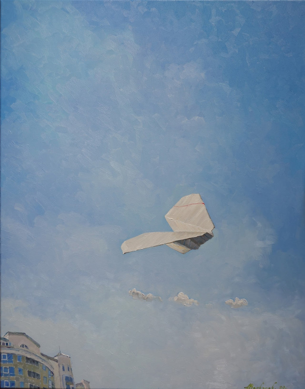 Paper airplane flying against a blue sky with buildings at the bottom