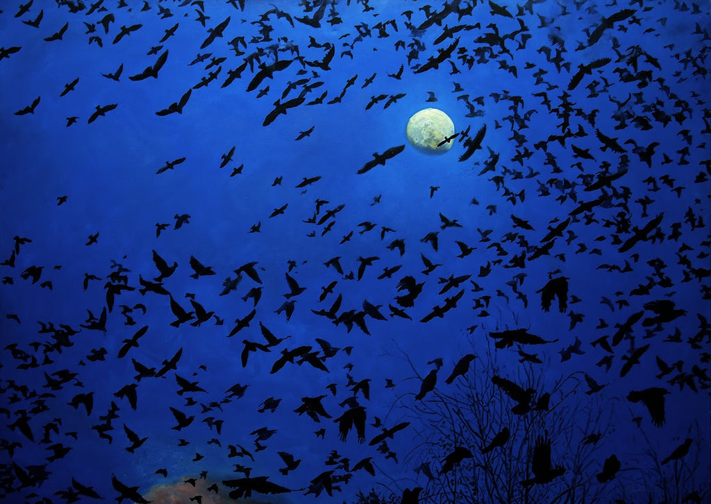Flock of birds flying against a dark blue sky with a full moon.