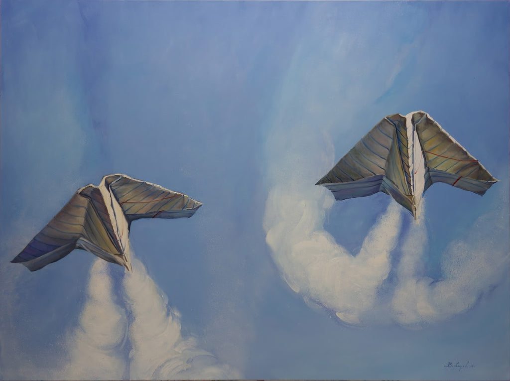Two paper airplane designs flying against a blue sky with white clouds.