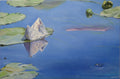 Paper boat floating on water with lily pads