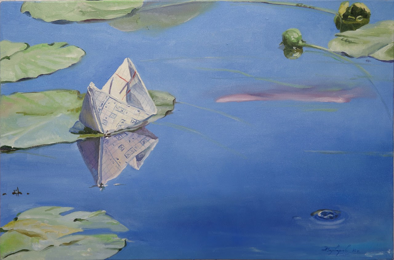 Paper boat floating on water with lily pads