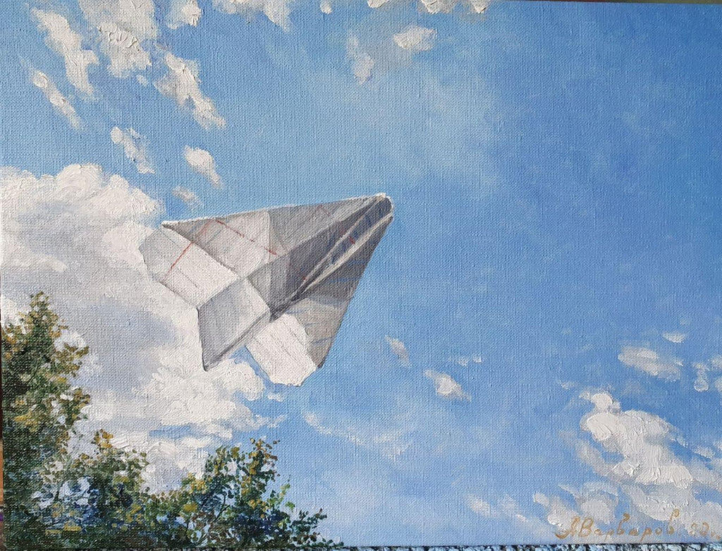 Paper airplane flying against a blue sky with clouds