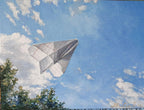 Paper airplane flying against a blue sky with clouds