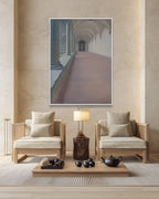 Modern living room with wooden chairs, a coffee table, and a large framed picture on the wall.