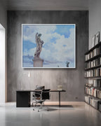 Modern office interior with a large framed artwork of a statue against a cloudy sky.