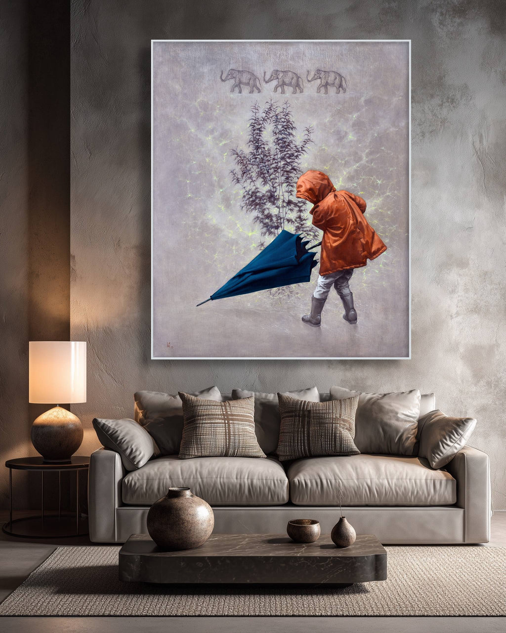 Living room with a sofa, coffee table, and wall art of a child with an umbrella and elephants.