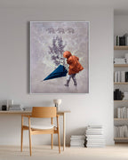 Framed artwork of a child with an umbrella in a room with a chair and books.