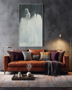 Living room with a brown sofa, colorful pillows, and a large abstract painting on the wall.
