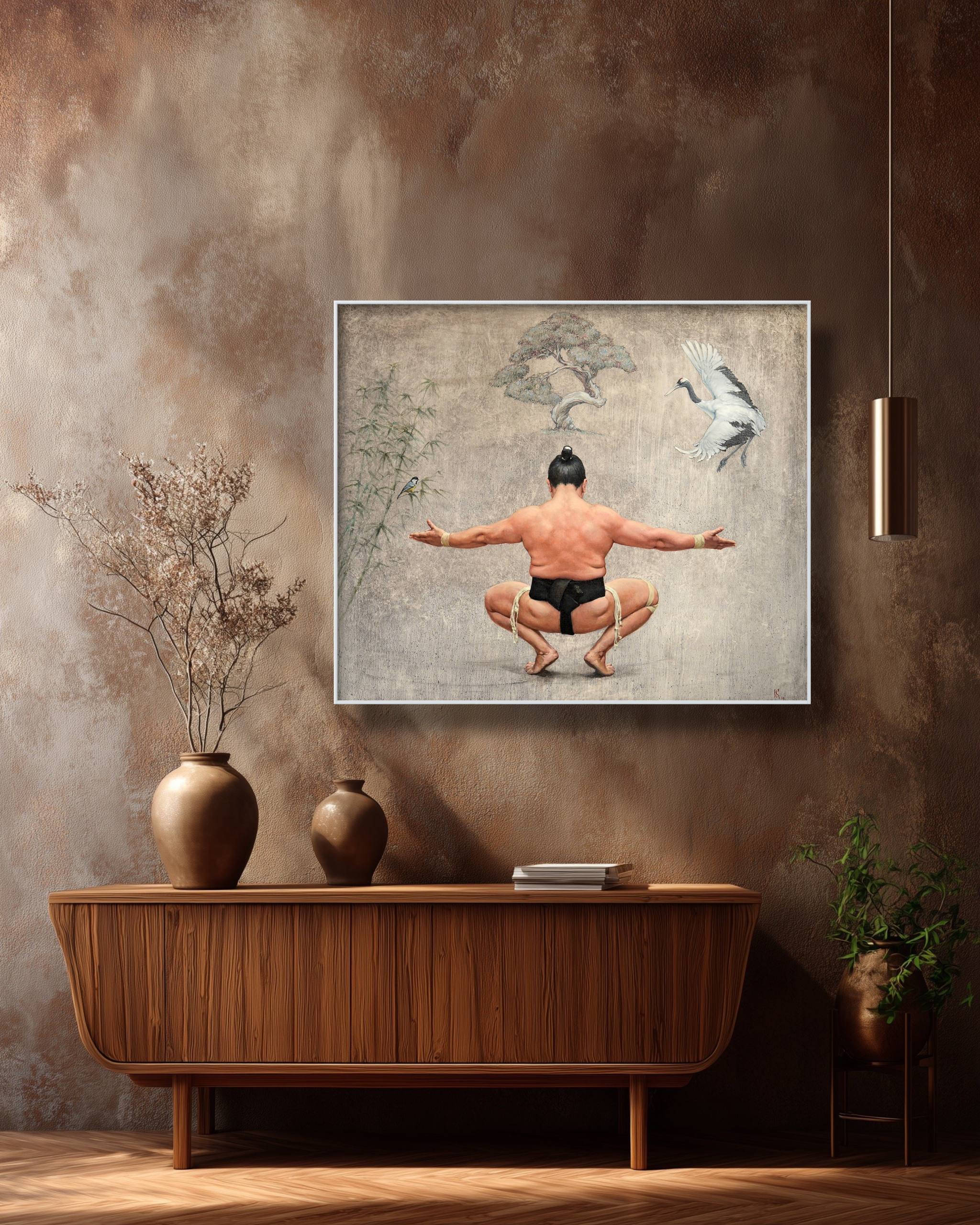 Framed artwork of a man in a meditative pose on a wall above a wooden console table.