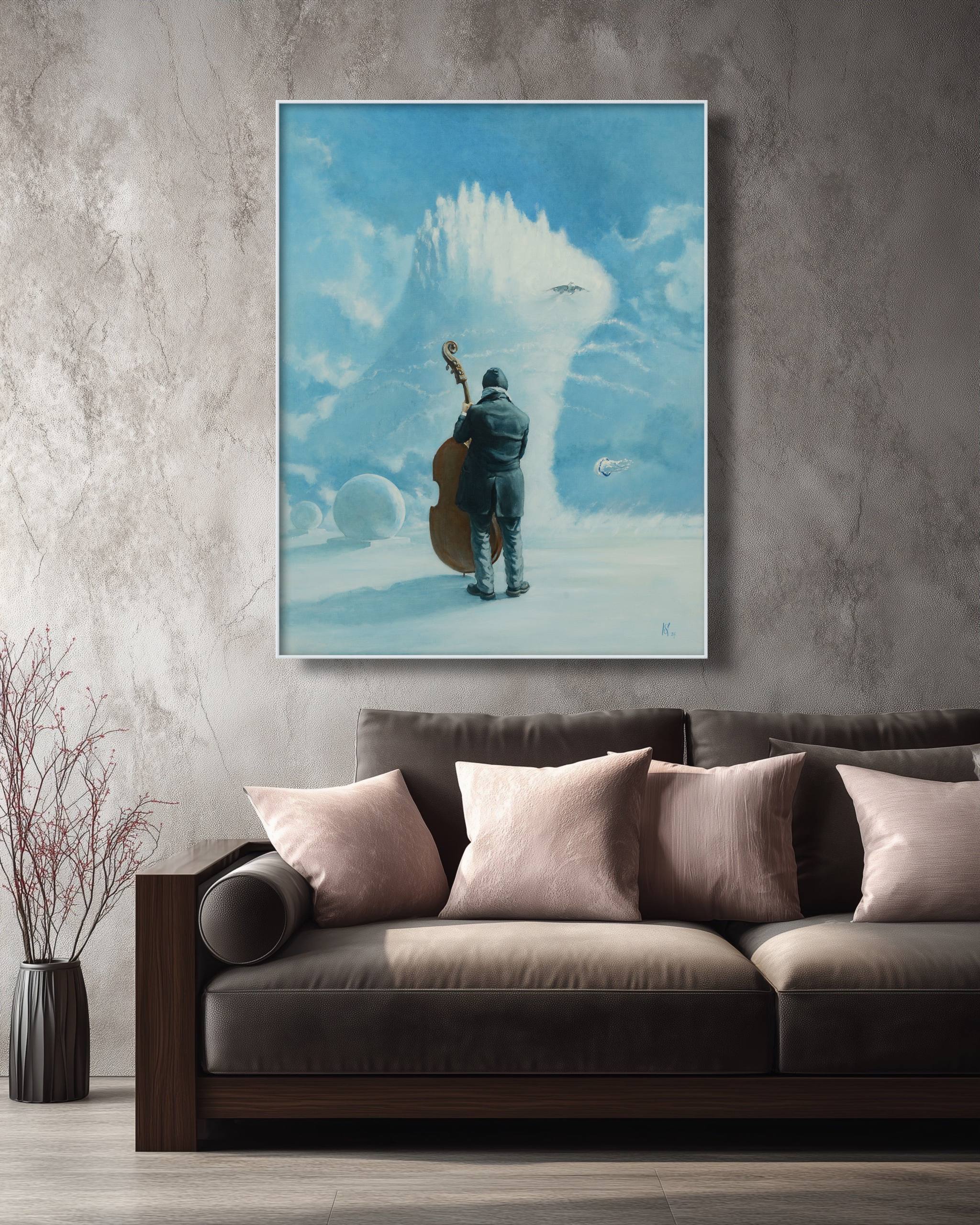 Framed artwork of a person with a cello against a blue sky above clouds, displayed on a wall above a sofa.