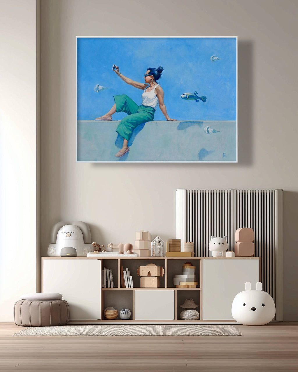 Framed artwork of a woman with fish on a wall above a shelf with decorative items.