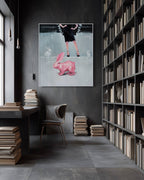 Modern interior with a bookshelf, desk, and artwork of a person with a pink rabbit on a dark wall.