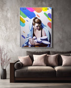 Colorful abstract painting of a woman holding a baby on a gray wall above a brown sofa.
