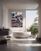 Modern bathroom with a large abstract painting on the wall, a freestanding bathtub, and a window with plants outside.
