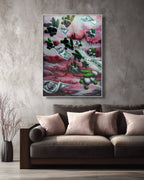 Abstract painting of money and cacti on a wall above a sofa.