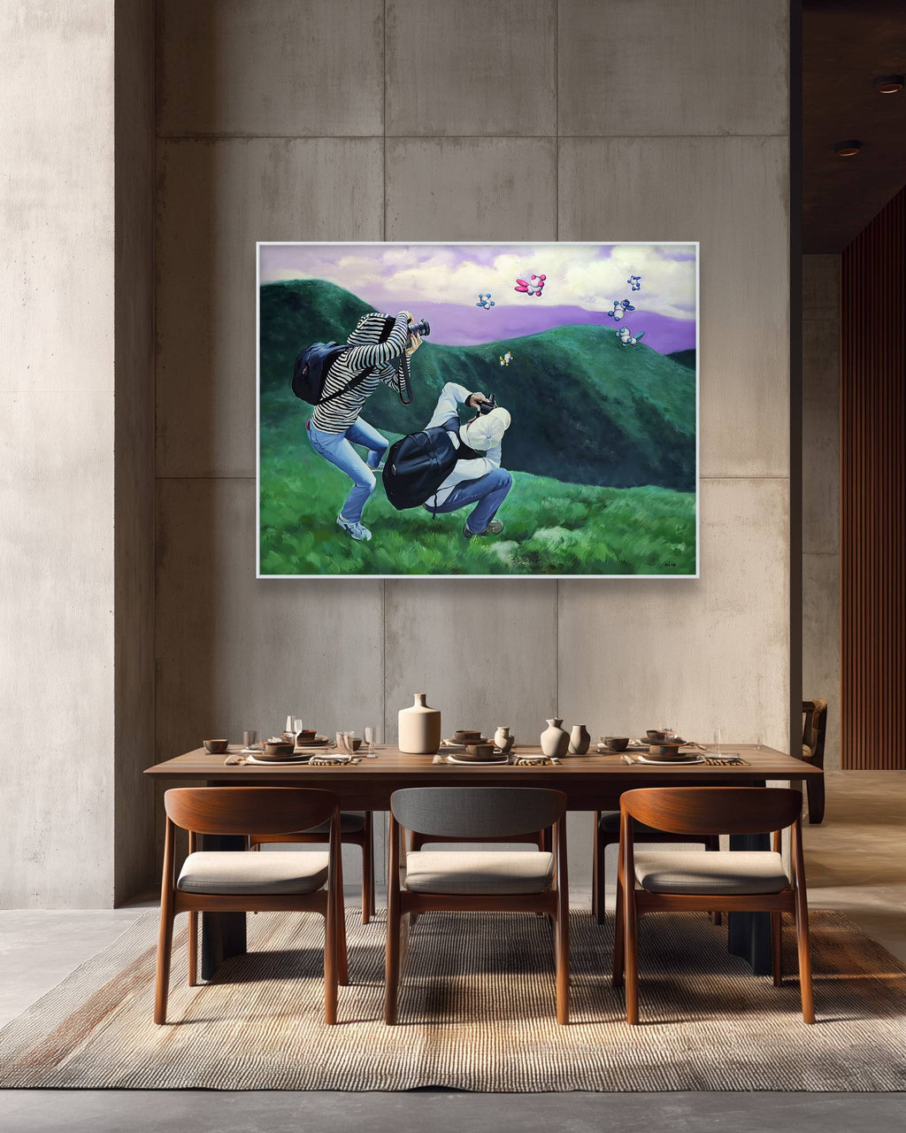 Dining room with a large painting of two people on a hillside above a wooden table.