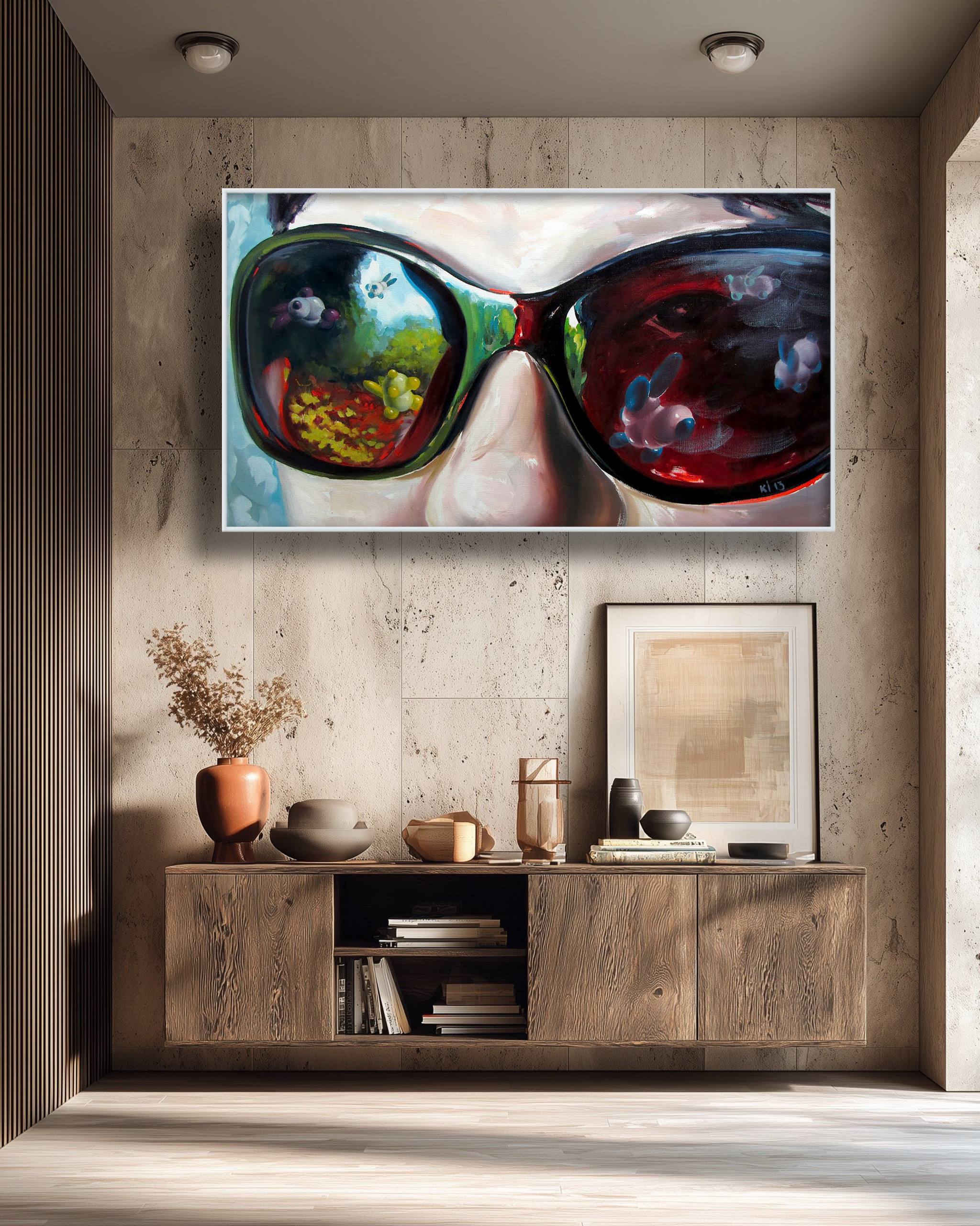Framed artwork of colorful sunglasses on a wall above a wooden cabinet.