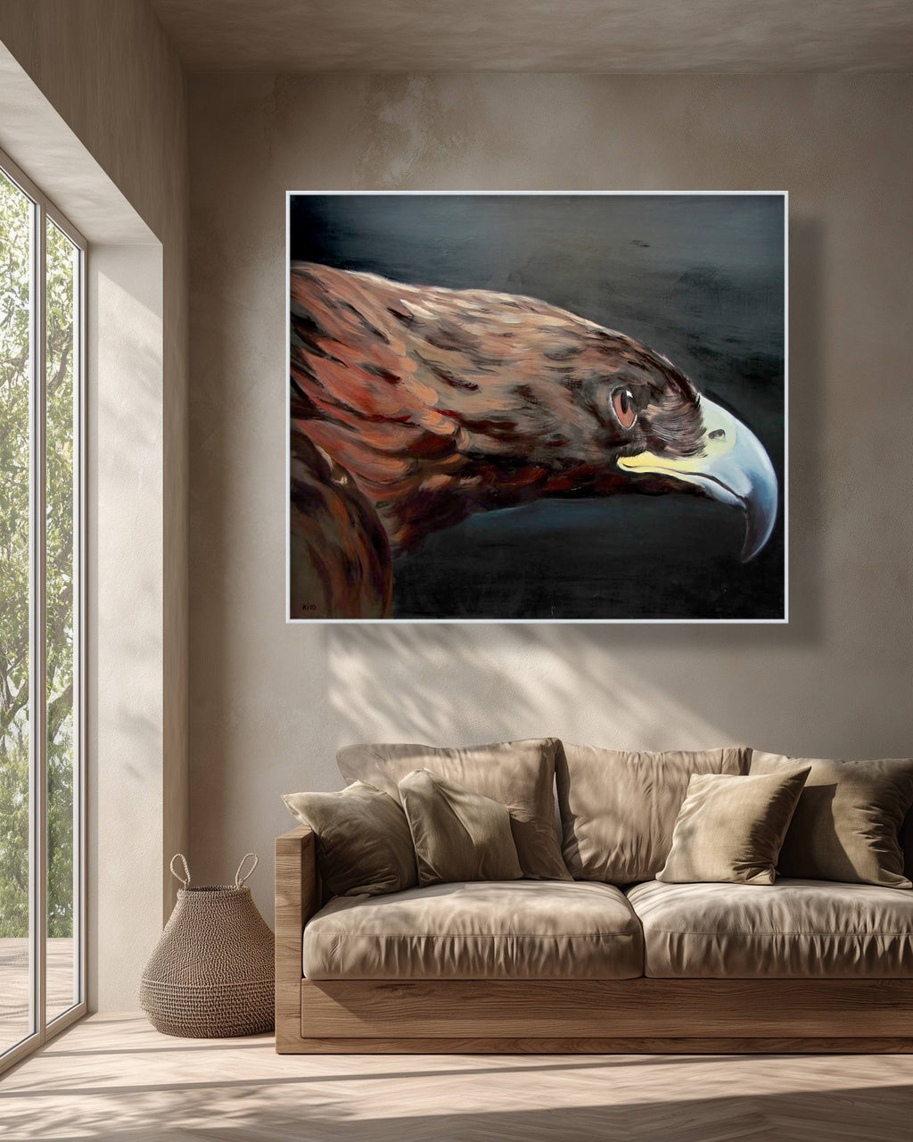 Framed artwork of an eagle on a wall above a sofa in a living room.